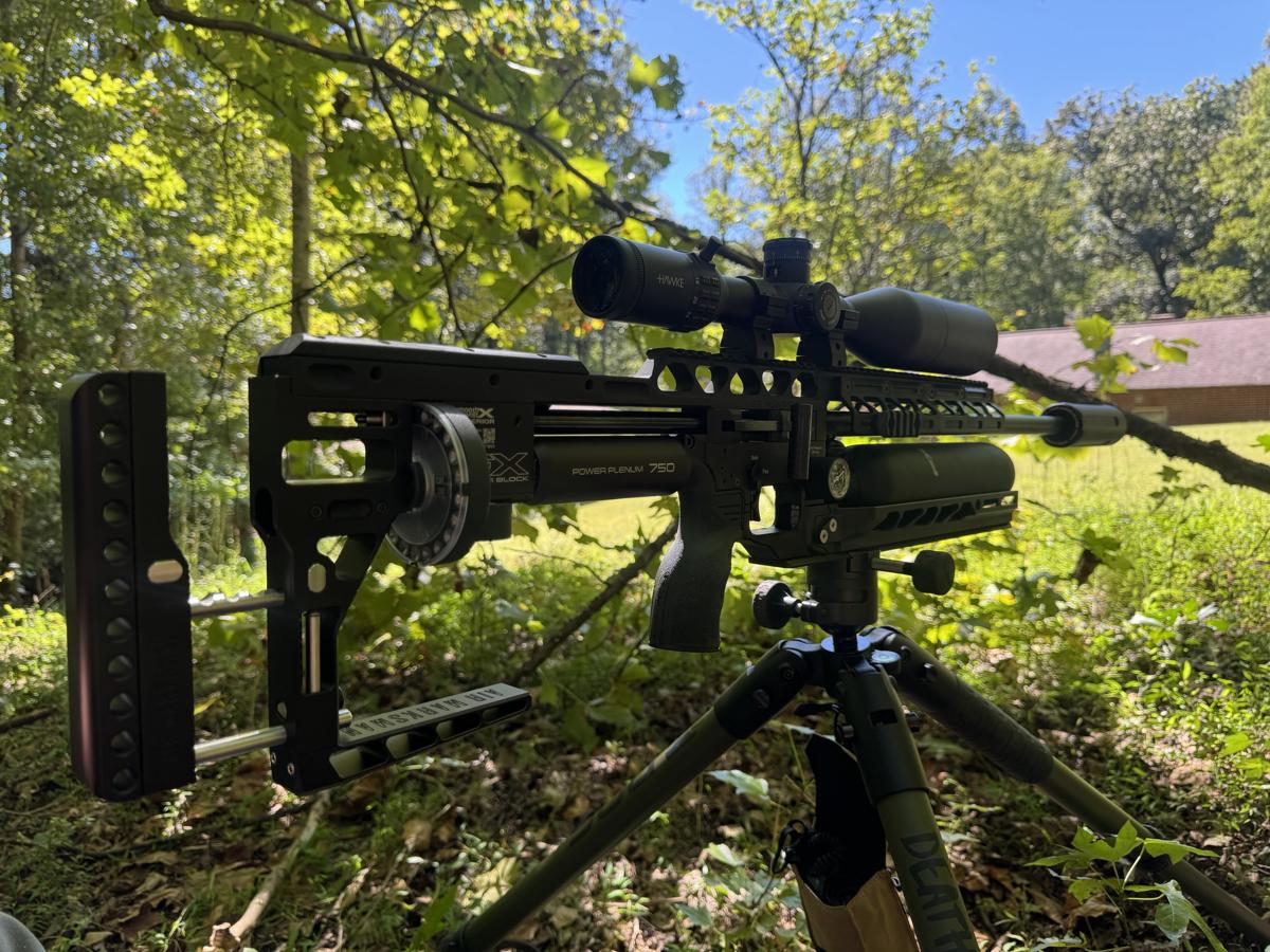 Precision air rifle on a tripod set up for a trap-shy groundhog